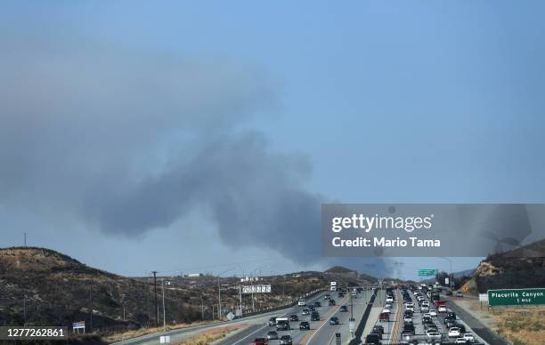 Motorists drive on the 14 freeway as the Martindale Fire burns in the Angeles National Forest on September 28, 2020 near Santa Clarita, California....
