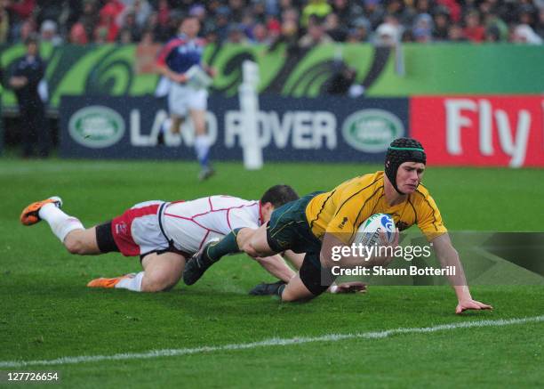 Berrick Barnes of Australia scores a try during the IRB 2011 Rugby World Cup Pool C match between Australia and Russia at Trafalgar Park on October...