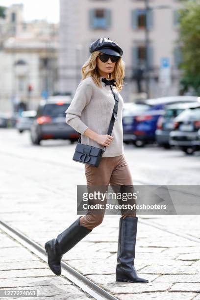 Influencer Gitta Banko, wearing a beige colored sweater with a bow by T7 Berlin, suede leggins by Seductive, black leather knee high boots by Isabel...
