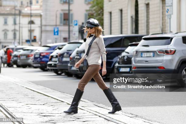 Influencer Gitta Banko, wearing a beige colored sweater with a bow by T7 Berlin, suede leggins by Seductive, black leather knee high boots by Isabel...