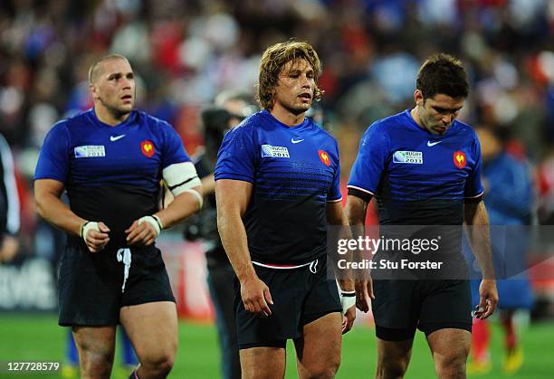 Dejected France players, Fabien Barcella, Dimitri Szarzewski and Dmitri Yachvili walk off the pitch following their team's 14-19 defeat during the...