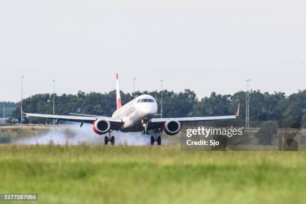 austrian airlines embraer erj-195l landing at schiphol airport - austrian culture stock pictures, royalty-free photos & images