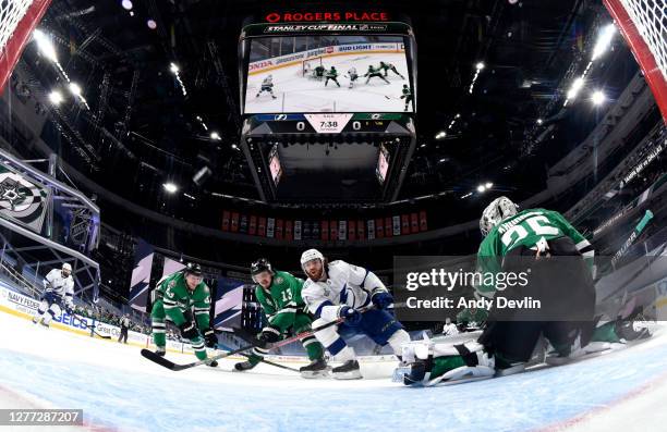 Goaltender Anton Khudobin of the Dallas Stars can't make the save on a shot for a goal by Brayden Point of the Tampa Bay Lightning in the first...