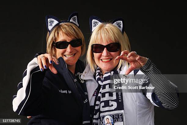 Geelong Cats fans pose for a portrait prior to the start of the 2011 AFL Grand Final match between the Collingwood Magpies and the Geelong Cats at...