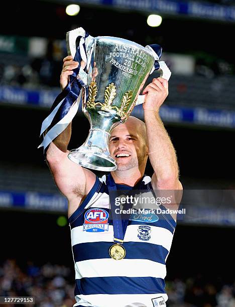 Paul Chapman of the Cats celebrates with the Premiership Cup after winning the 2011 AFL Grand Final match between the Collingwood Magpies and the...