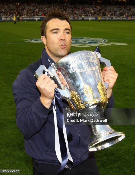 Chris Scott coach of the Geelong Football Club celebrates with the Premiership Cup after winning the 2011 AFL Grand Final match between the...