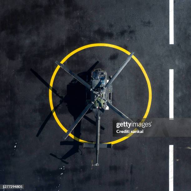 military helicopter at helipad - helicopter helipad stock pictures, royalty-free photos & images