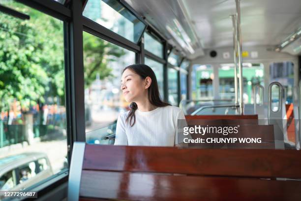 young tourist woman on double decker cable car-hong kong - young woman trolley stock pictures, royalty-free photos & images