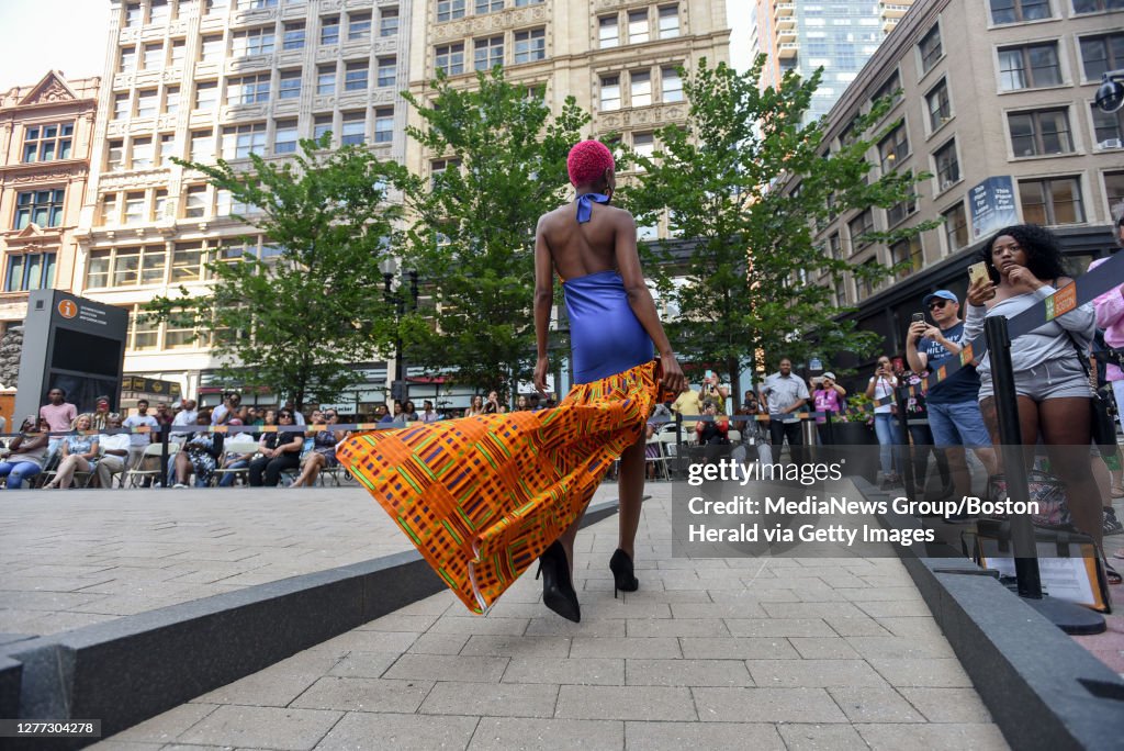 BOSTON, MA- AUGUST 09, 2019:   Boston Caribbean Fashion Week, Caribbean Catwalk Fashion Show in Downtown Crossing- Representing the US, model, Mpodi Tulloch, 35 from Boston shows off emerging designer, Ayanna O'Brien's bright and bold summer daywear, coll