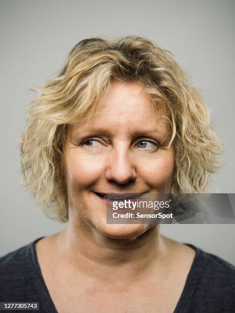 portrait of a real caucasian adult woman with funny expression looking to the side - sneering stock pictures, royalty-free photos & images