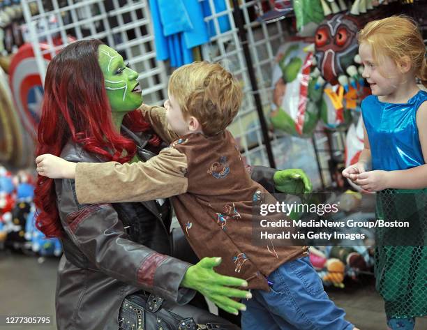 Luc Calore 5 of Cumberland, RI gives Shellana Demarest Orlando FL a hug as his twin Arabella looks on during the Fan Expo at the BCEC on August 16,...