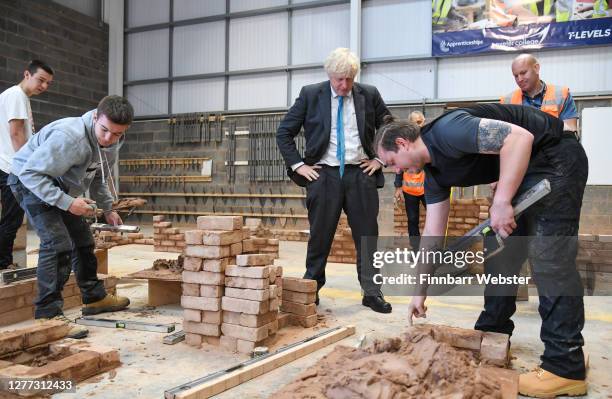 British Prime Minister Boris Johnson during his visit to Exeter College on September 29, 2020 in Exeter, England. In a bid to mitigate rising...