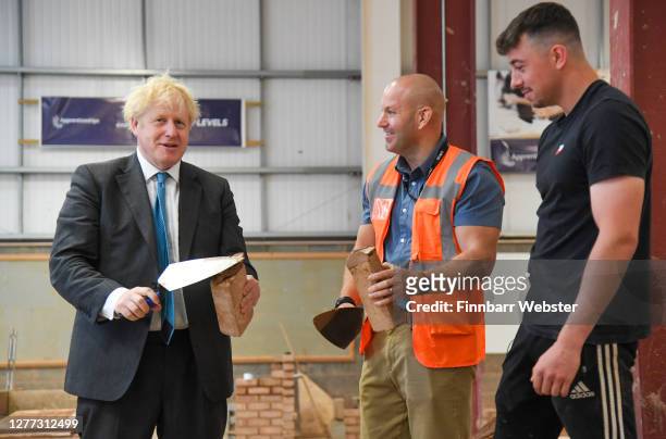 British Prime Minister Boris Johnson during his visit to Exeter College on September 29, 2020 in Exeter, England. In a bid to mitigate rising...
