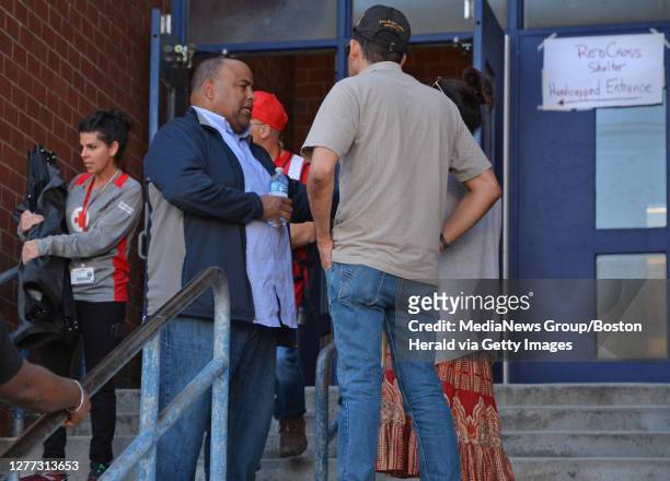 Mayor Daniel Rivera talks with people as they leave the emergency shelter at Arlington Middle school September 27, 2019 in LAWRENCE, Massachusetts.