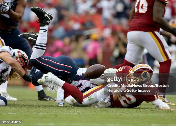 Washington Redskins quarterback Colt McCoy fumbles the ball as he is sacked by New England Patriots outside linebacker Jamie Collins during the 4th...