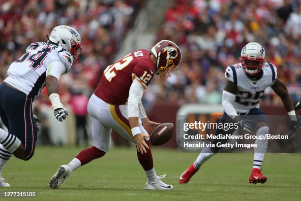 Washington Redskins quarterback Colt McCoy fumbles the ball under pressure from New England Patriots' Dont'a Hightower and Terrence Brooks during the...