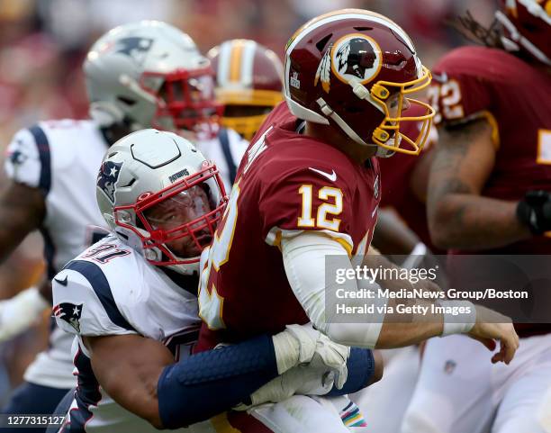 New England Patriots defensive end Deatrich Wise gets to Washington Redskins quarterback Colt McCoy during the 3rd quarter of the game at FedEx Field...