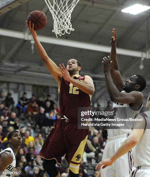 Boston College Eagles forward Ryan Anderson shoots the ball over Harvard Crimson's Wesley Saunders , left, Steve Moundou-Missi and Laurent Rivard and...