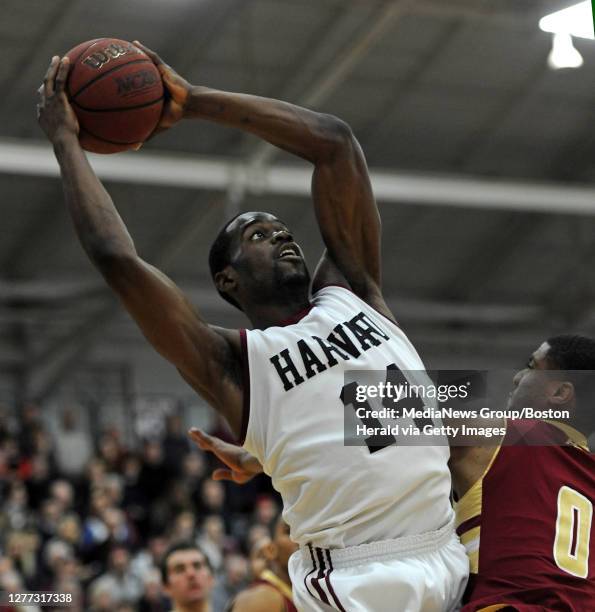 Harvard Crimson forward Steve Moundou-Missi hauls in a rebound over Boston College Eagles' Garland Ownens during the first half of their NCAA...