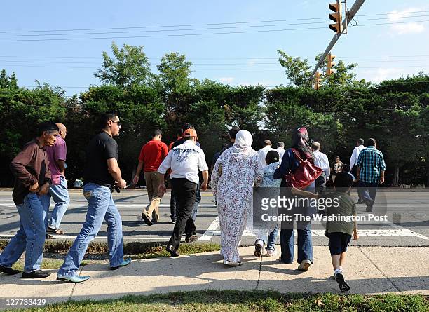 Folks cross Route 7 en route to Dar al-Hijrah Mosque before midday Friday prayers on September 30 in Falls Church, VA. U.S.-born al-Qaeda leader...