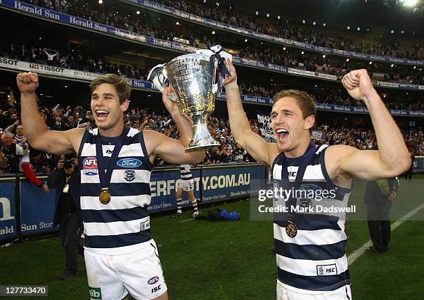 Tom Hawkins and Joel Selwood of the Cats celebrate with the Premiership Cup after winning the 2011 AFL Grand Final match between the Collingwood...