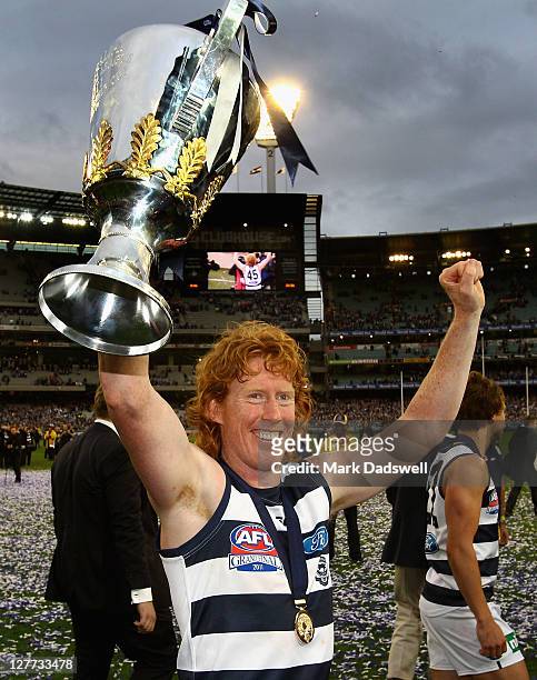 Cameron Ling of the Cats celebrates with the Premiership Cup after winning the 2011 AFL Grand Final match between the Collingwood Magpies and the...