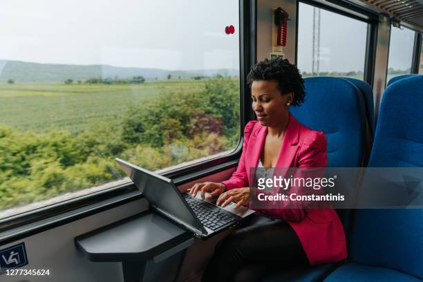 commuter working from the train - train window stock pictures, royalty-free photos & images