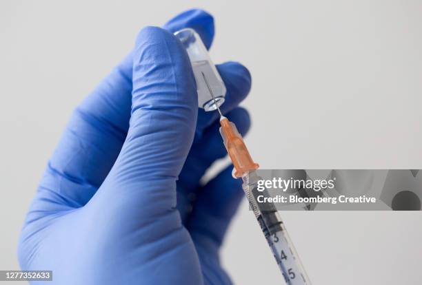 medical syringe and glass vial - person studio shot stock pictures, royalty-free photos & images