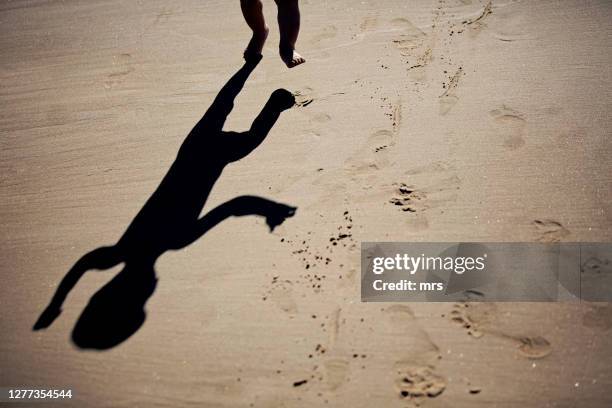 happy baby walking on sand - baby fußabdruck stock-fotos und bilder