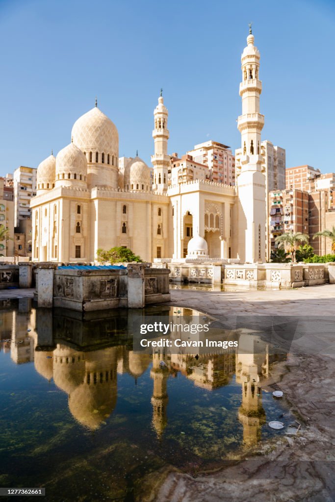 Reflection of a mosque in a puddle in Alexandria, Egypt