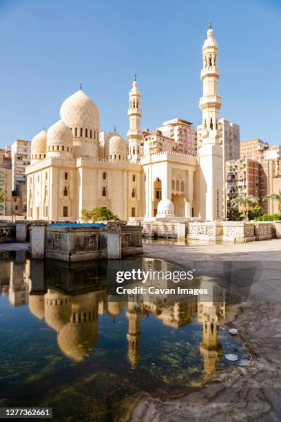 reflection of a mosque in a puddle in alexandria, egypt - alexandria stock pictures, royalty-free photos & images