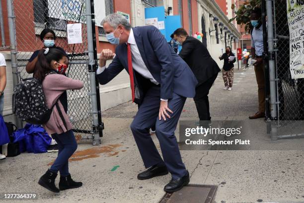 New York City Mayor Bill de Blasio elbow bumps a student at P.S. 188 as he welcomes elementary school students back to the city's public schools for...