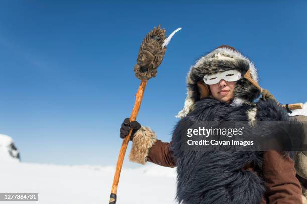 native american hunter dressed in traditional fur clothing. - arctic explorer stock pictures, royalty-free photos & images