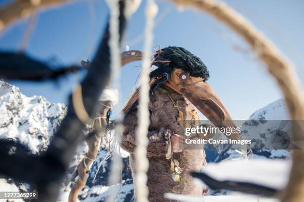 first nations person dressed in ravens mask preforms a ceremony. - beak mask stock pictures, royalty-free photos & images