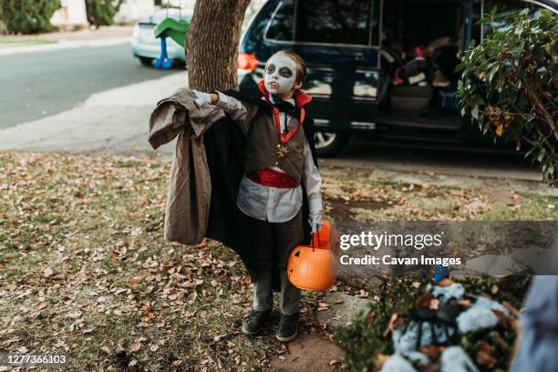 elementary age boy holding out bag of candy on halloween - pillow case stock pictures, royalty-free photos & images