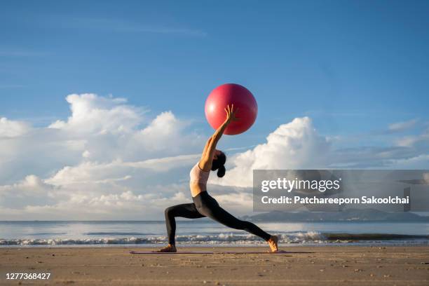 professional training yoga on the beach - fitness ball stock pictures, royalty-free photos & images