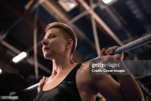 tired sportswoman preparing to squat with with barbell - inside of train stock pictures, royalty-free photos & images