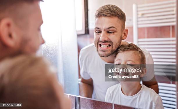 like father like son - tooth bonding stock pictures, royalty-free photos & images