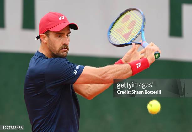 Steve Johnson of the United States plays a backhand during his Men's Singles first round match against Roberto Carballes Baena of Spain on day three...