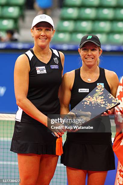 Liezel Huber and Lisa Raymond of the United States pose with the trophies after playing their doubles final match against Gisela Dulko of Argentina...