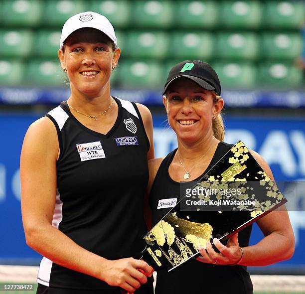 Liezel Huber and Lisa Raymond of the United States pose with the winners trophy after their doubles final match against Gisela Dulko of Argentina and...