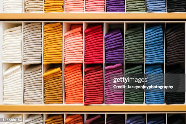 colorful horizontal various socks on wooden shelf in cloth store - clothing store stockfoto's en -beelden