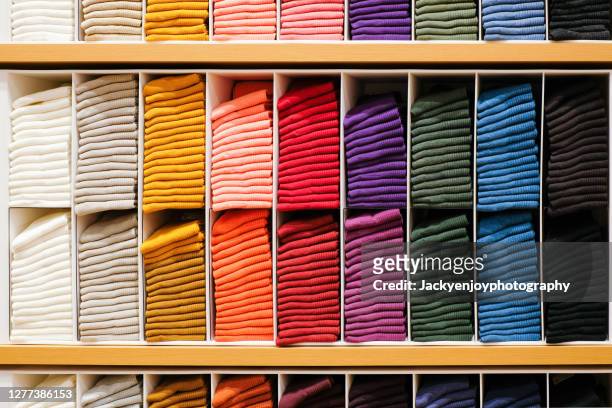 colorful horizontal various socks on wooden shelf in cloth store - fashion orange colour stock pictures, royalty-free photos & images