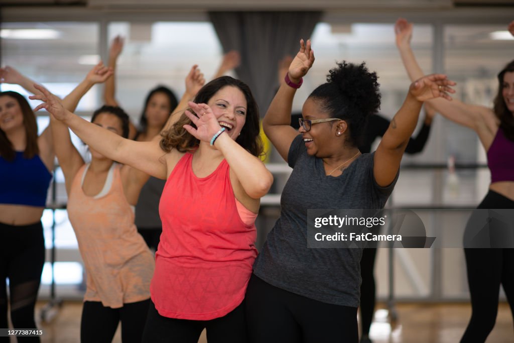 Women having fun dancing in fitness class