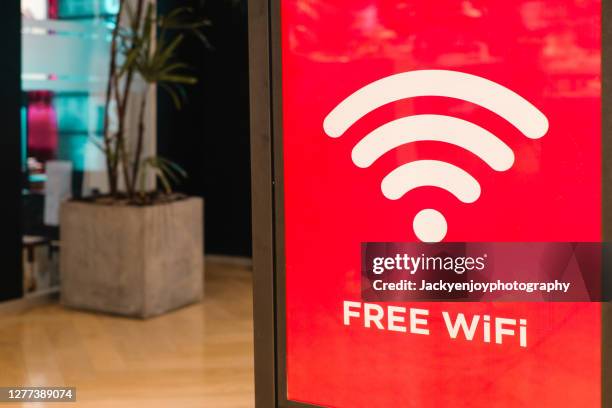 free wifi message on red background in shopping mall - free wifi signs fotografías e imágenes de stock