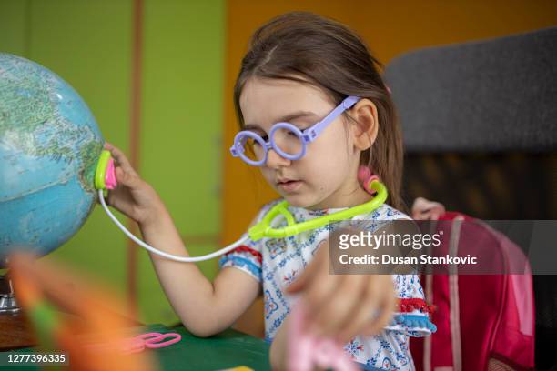 preschool girl playing a doctor - world children day stock pictures, royalty-free photos & images