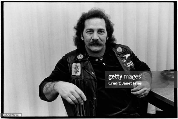 Portrait of American biker and founding member of the Oakland chapter of the Hells Angels Sonny Barger as he sits at a table, San Francisco,...