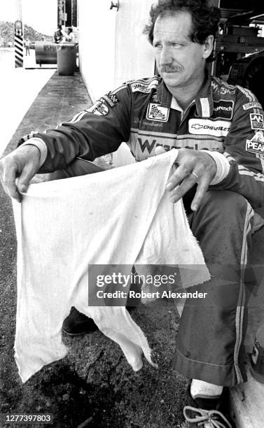 Driver Dale Earnhardt, Sr. Cools off in the speedway garage after competing in the 1983 Firecracker 400 stock car race at Daytona International...