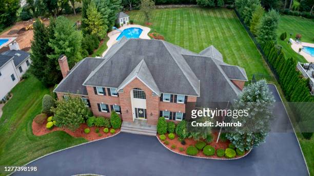 large house in affluent neighborhood aerial, front view - rooftop pool imagens e fotografias de stock