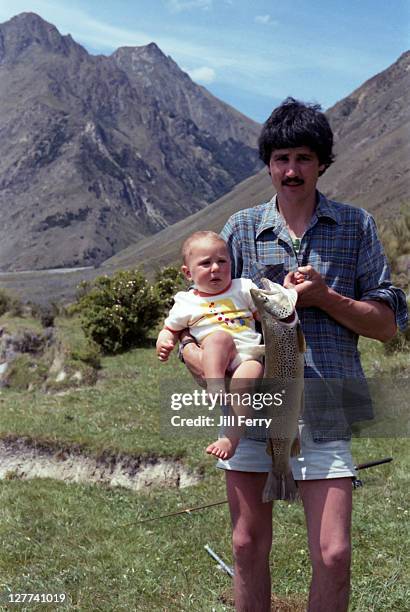 man holding fish and child - archival family stock pictures, royalty-free photos & images
